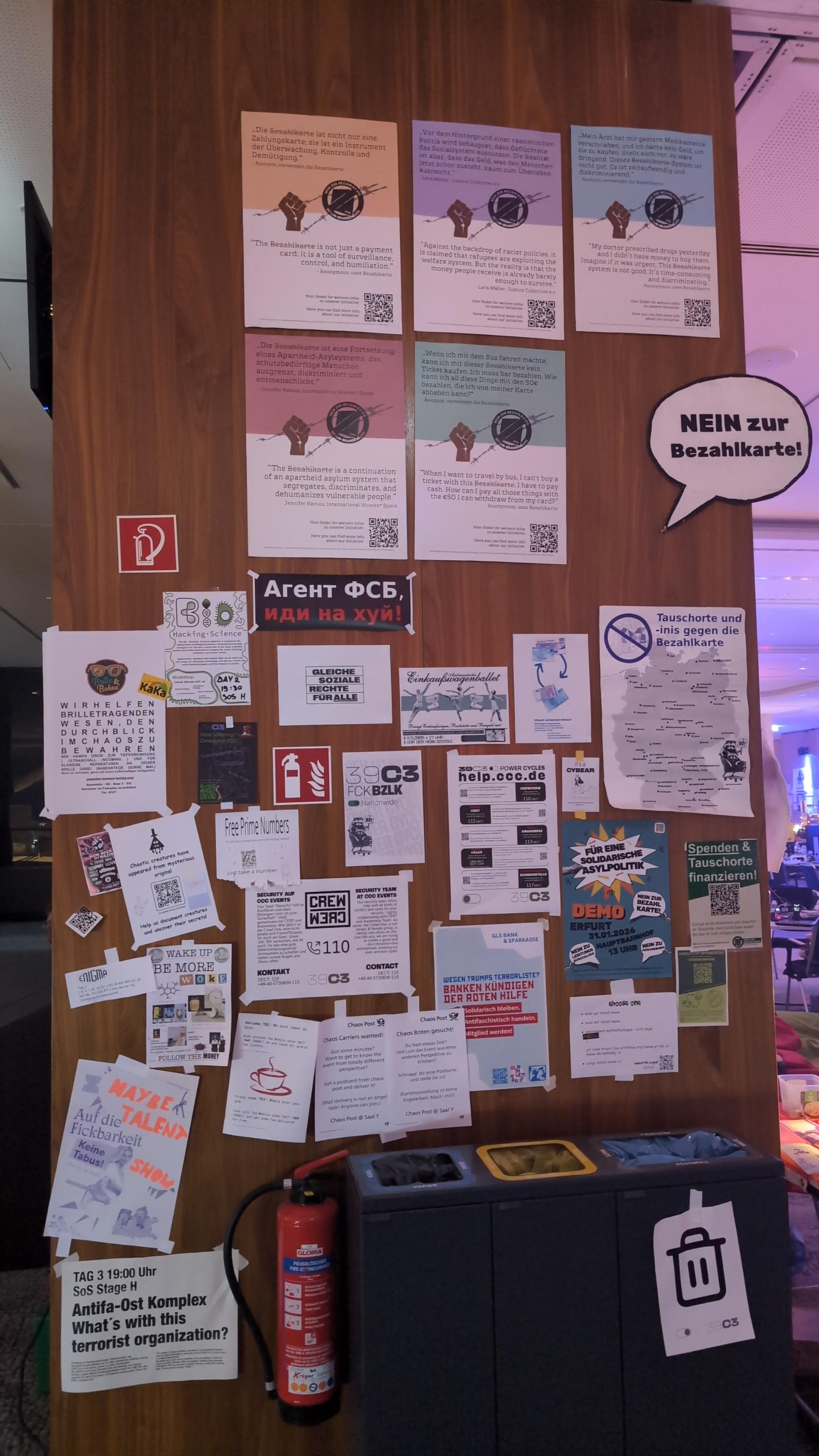 Picture of a wooden wall. It's completely covered by several dozens of signs.